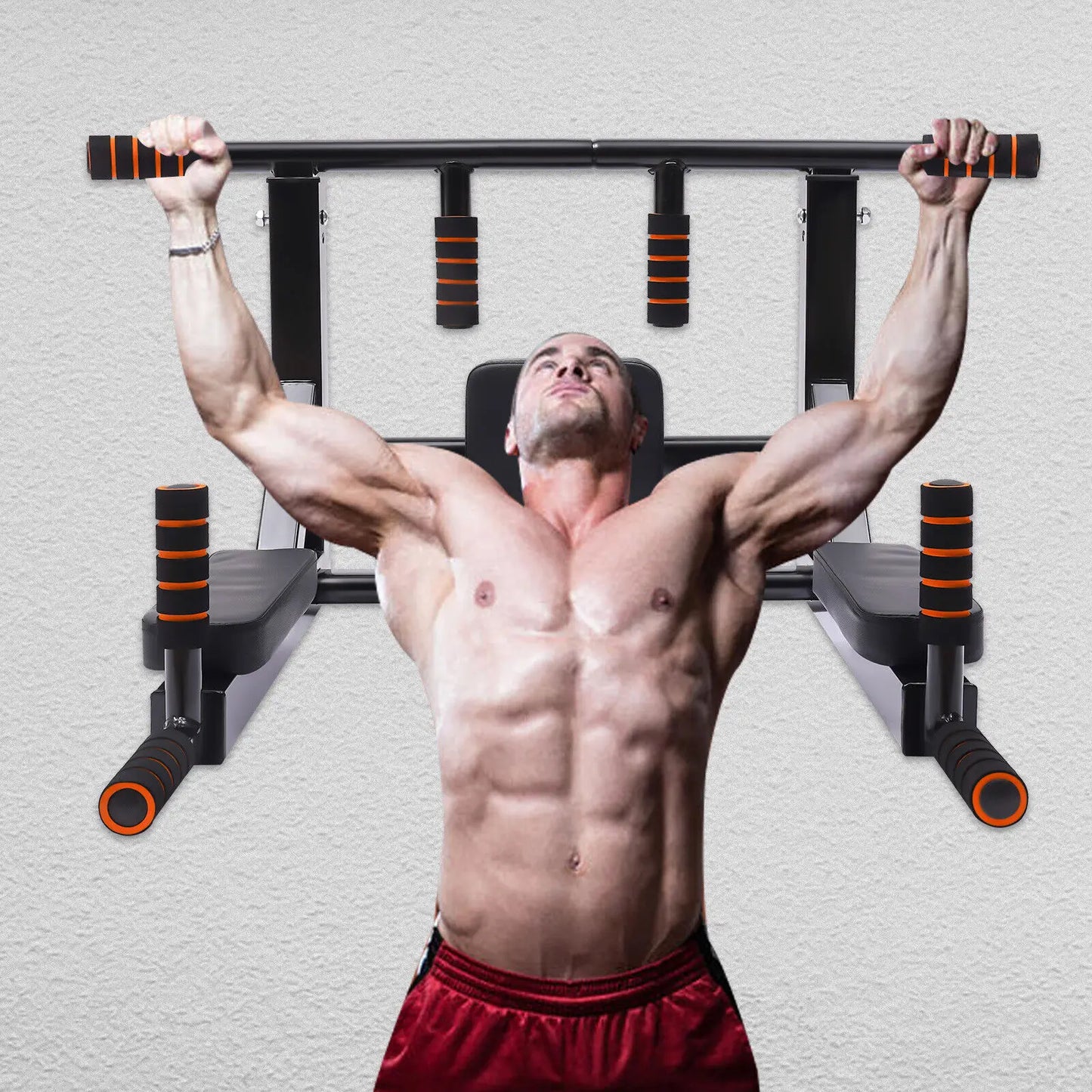 Man performing pull-ups on a wall-mounted pull-up bar against a gray background